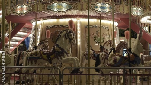Incredible colorful flashing light of vintage carousel carnival fair merry go round circus horse ride at amusement park