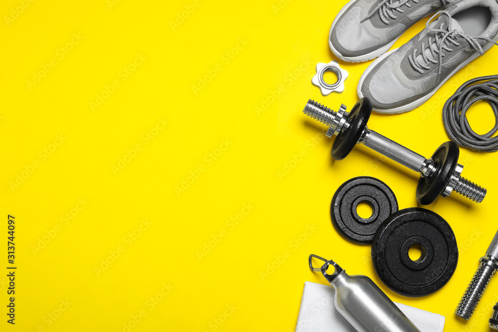 Gym equipment on yellow background, flat lay. Space for text - obrazy, fototapety, plakaty 