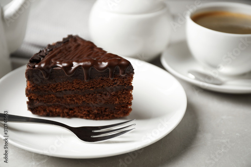 Tasty chocolate cake served on white table, closeup