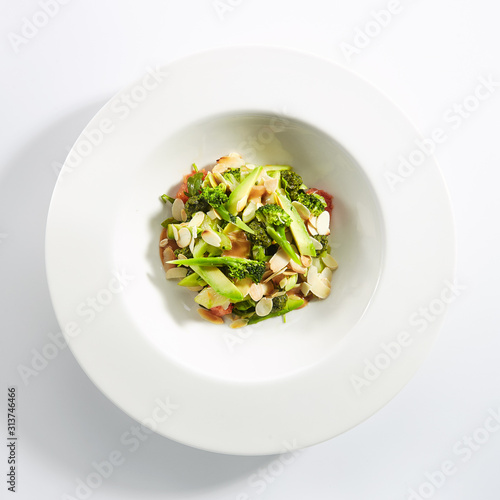 Salad with Avocado, Broccoli, Cucumber and Almonds Isolated