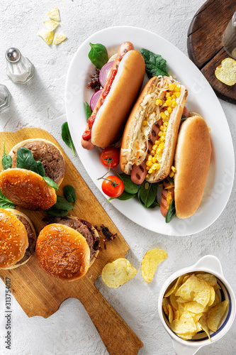 Canvas Print Party dinner table with different homemade hot dogs and burgers top view