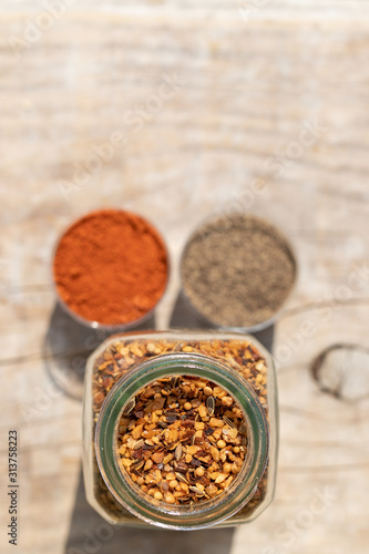 Two jars with spices of different grinding and two small bowls w