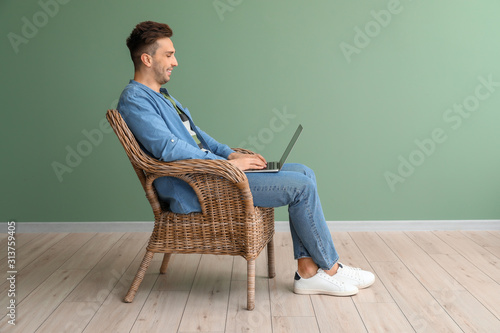 Handsome man with laptop si...