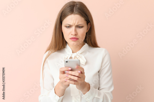 Sad businesswoman with mobi...