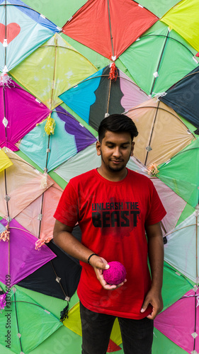 Young Man with Thread ball for makar sankranti. Makar sankranti is an Indian kite festival. It is also known as uttarayan photo