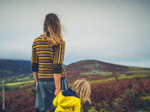 Young mother and toddler walking on the moor in autumn