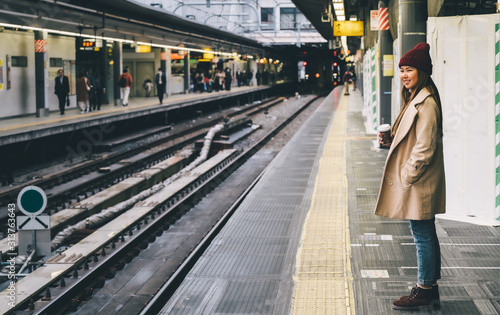 young woman in train station travel concept background vintage tone.