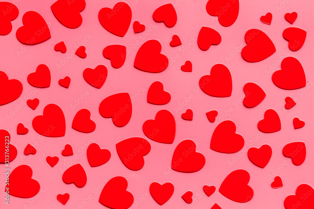 Red hearts pattern - Valentine's Day concept - on pink background top-down