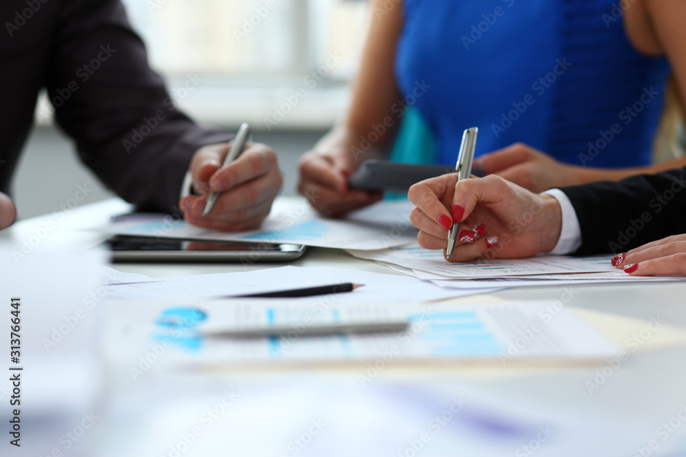 Silver pen lie on important paper at table Silver pen lie on important paper at table