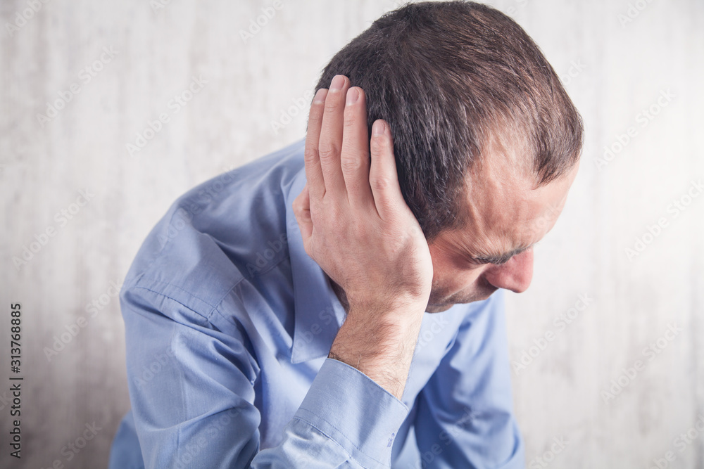 Businessman feels ear pain. Healthcare and Medicine Businessman feels ear pain. Healthcare and Medicine