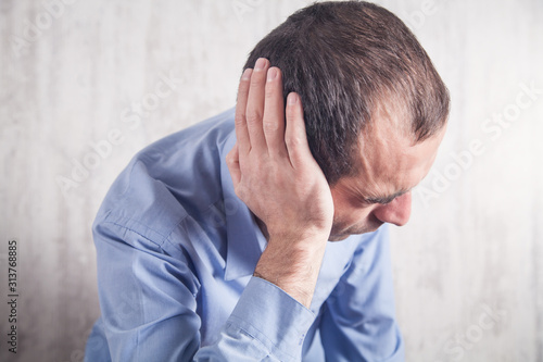 Businessman feels ear pain. Healthcare and Medicine