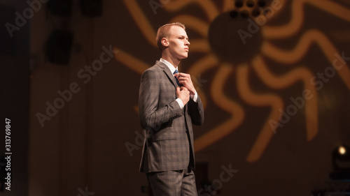 Fotografie male model, adjusting his tie during a fashion show
