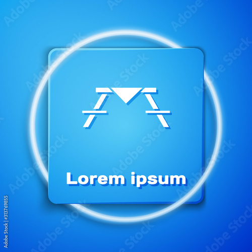 White Picnic table with benches on either side of the table icon isolated on blue background. Blue square button. Vector Illustration