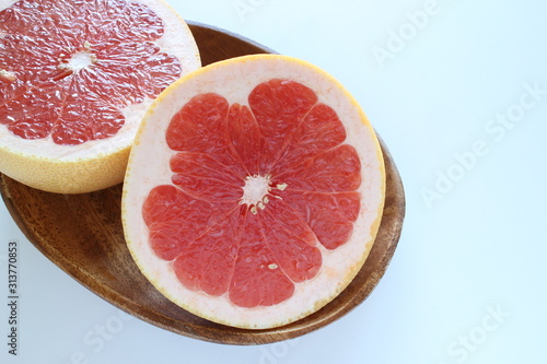 Cut fruit, red ruby grapefruit on dish for healthy dessert