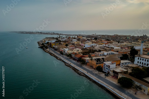 Aerial panorama of Sant Louis, a unesco heritage city in northern Senegal. View from Senegal river towards the old colonial city and fisherman island. © Anze