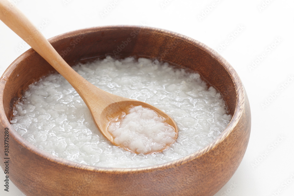 Chinese food, healthy rice congee in wooden bowl Chinese food, healthy rice congee in wooden bowl