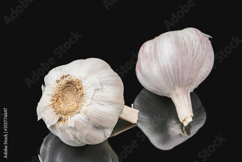 The concept of healthy eating. Heads of garlic on a dark background