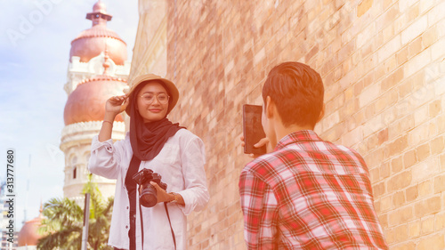 Photography Travel Concept, Muslim Tourist Couple at Kuala Lumpur