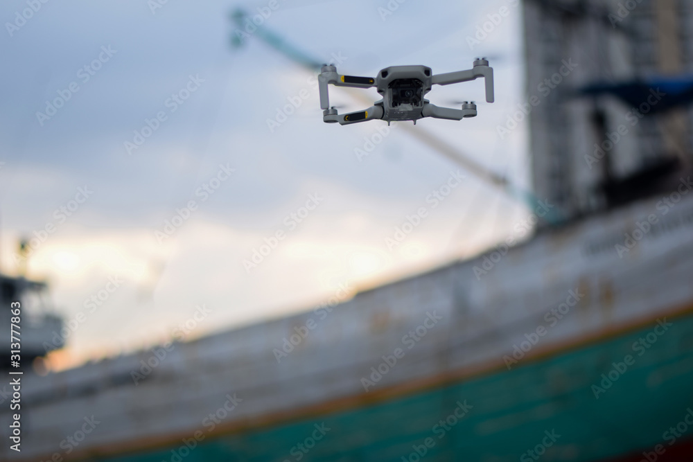 Close up Fly Grey Drone on Port Industrial Jakarta Close up Fly Grey Drone on Port Industrial Jakarta
