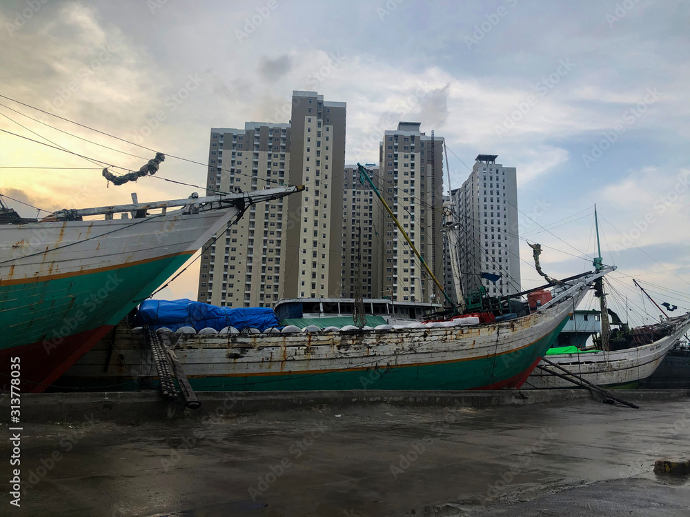 Traditional industrial port with containers from top view or aerial view. It is an import and export cargo port at Sunda Kelapa - Jakarta Traditional industrial port with containers from top view or aerial view. It is an import and export cargo port at Sunda Kelapa - Jakarta