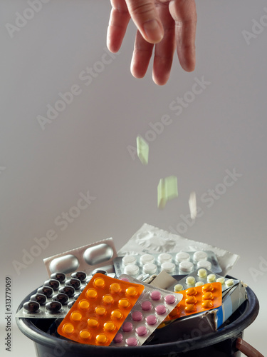 Expired medicines are in the bin. Vertical medicinal background. photo