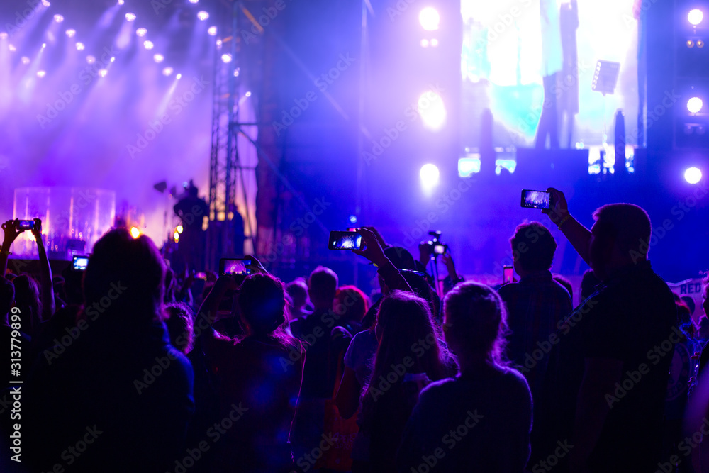 music concert at night on the street, youth with phones