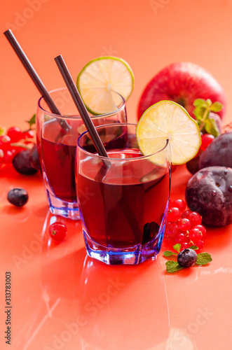 Fruit juice rich of anthocyanins  oligominerals for health in glass on colored background.