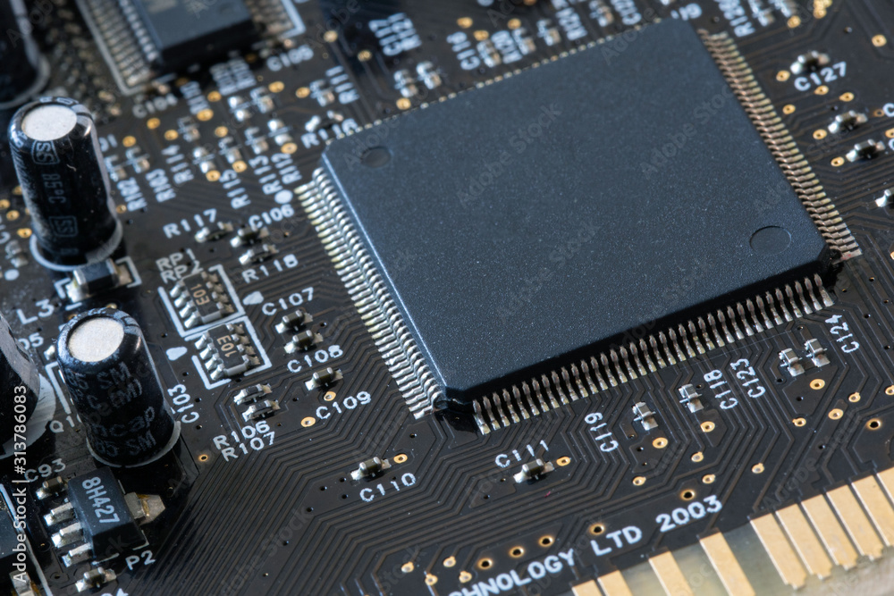 Photo of electric component in electronic device, contain black microchip as main object. Photo of electric component in electronic device, contain black microchip as main object.