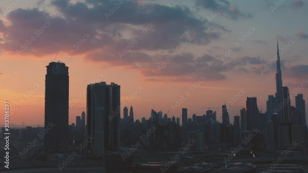 AERIAL. Top view of downtown Dubai and flock of birds flying close to the camera. AERIAL. Top view of downtown Dubai and flock of birds flying close to the camera.