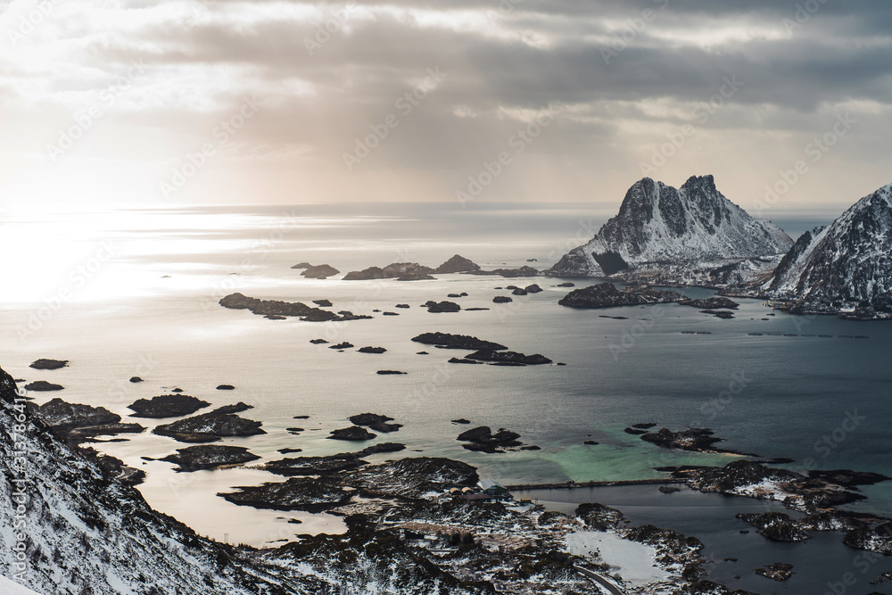 View of a landscape of a Norwegian fjord with a snowy mountain and rocks, Lofoten Islands