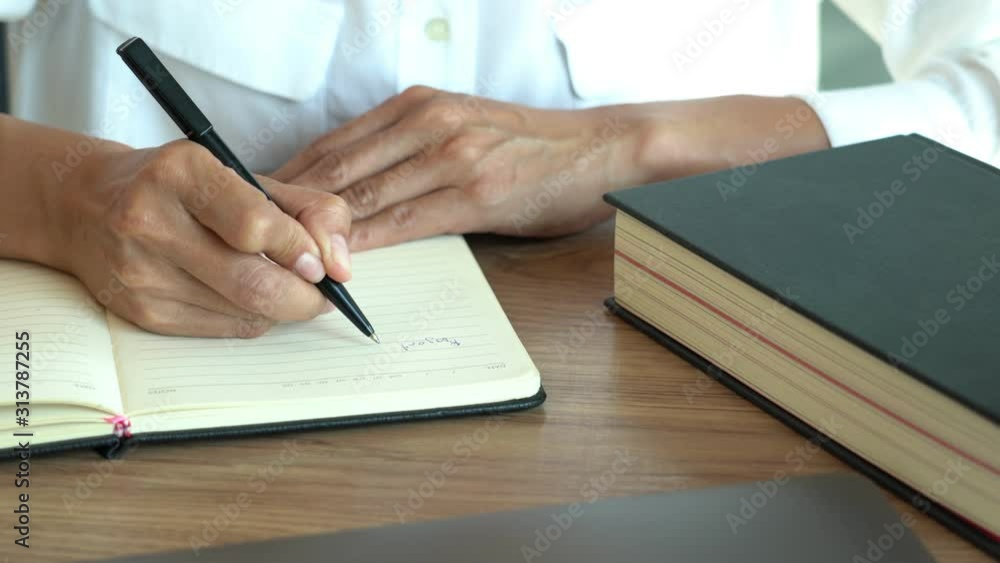 4k video of man hand holding pen writing to do list or business data with pen at notebook dairy 4k video of man hand holding pen writing to do list or business data with pen at notebook dairy
