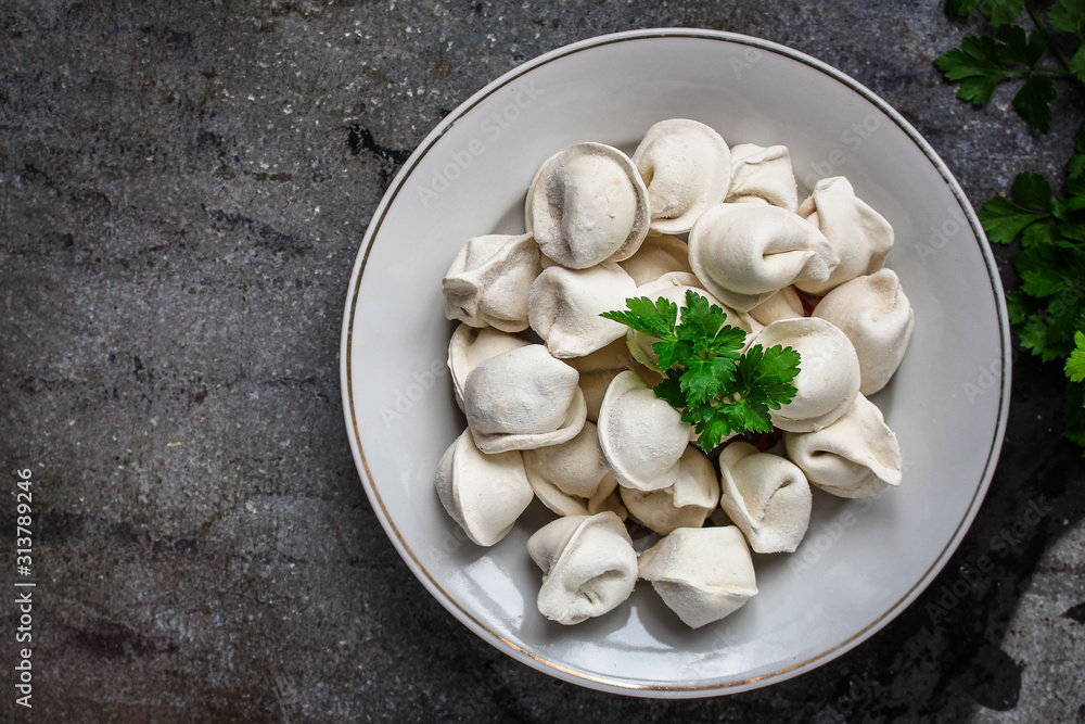 tortellini with filling (ravioli dumplings) menu concept. food background. top view. copy space