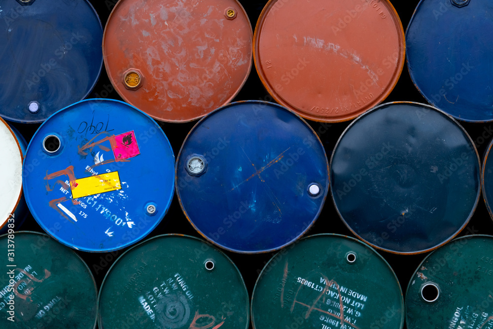 Old chemical barrels. Blue, green, orange oil drum. Steel oil tank. Toxic waste warehouse. Hazard chemical barrel with warning label. Industrial waste in metal drum. Hazard waste storage in factory. Old chemical barrels. Blue, green, orange oil drum. Steel oil tank. Toxic waste warehouse. Hazard chemical barrel with warning label. Industrial waste in metal drum. Hazard waste storage in factory.