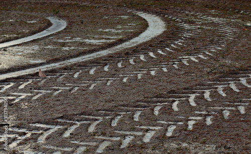 Curved tracks of a tractor on frozen ground