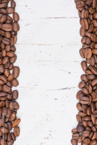 Coffee beans on a white textured background, empty copy space