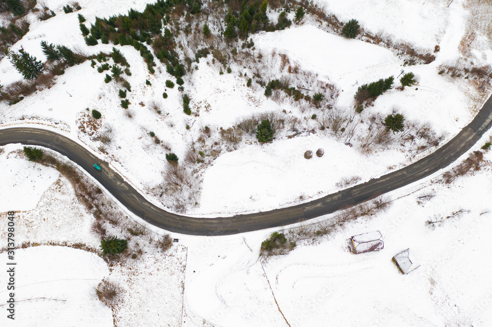 Snowy rural road aerial view.