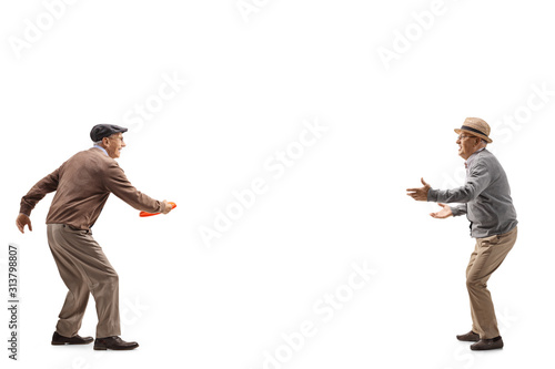 Two senior men playing with a plastic disk