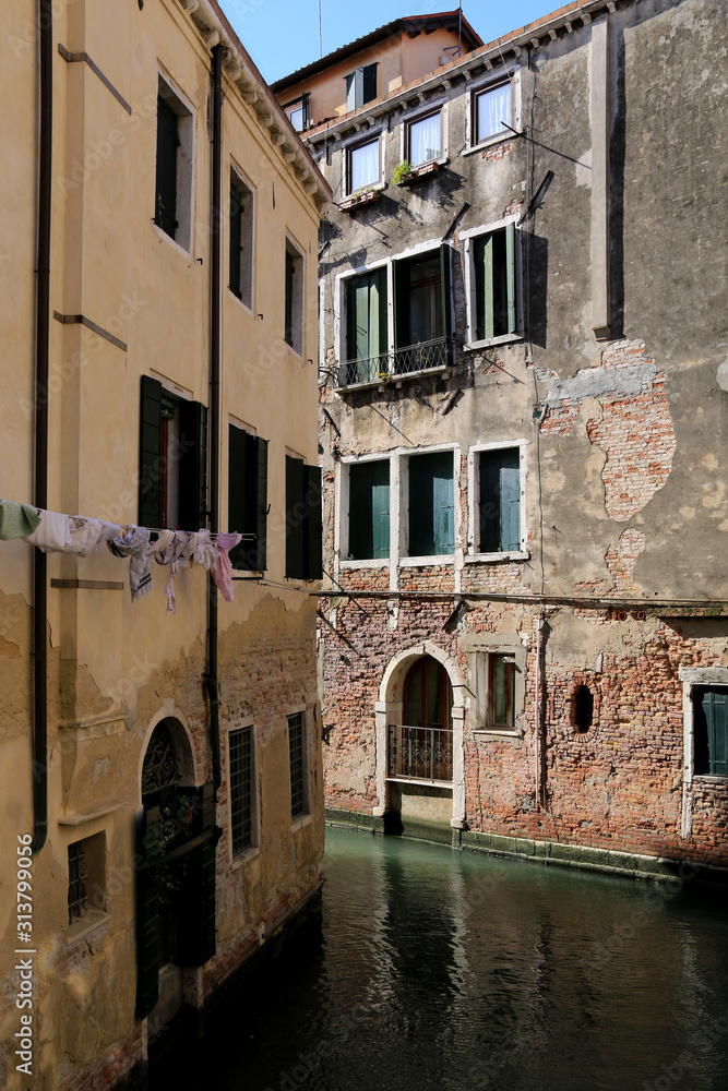 Narrow canal in the residential area of Venice, Italy