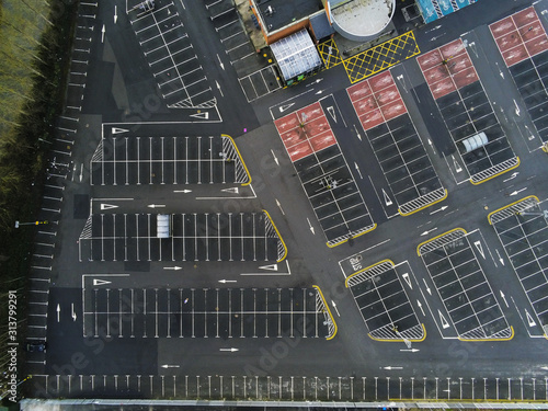 Aerial view on empty car park by a shopping center.