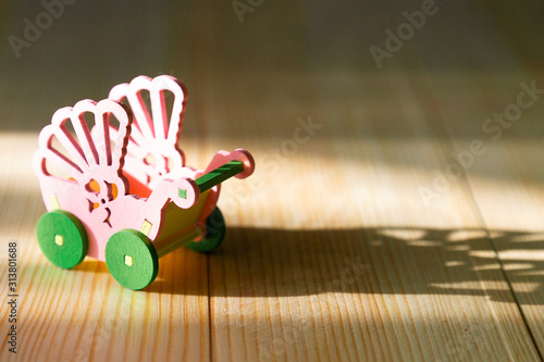 Empty pram on a wooden background. Infertility concept, lack of children in the family, empty pram photo