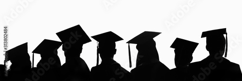 Foto Silhouettes of students with graduate caps in a row isolated on white panoramic background