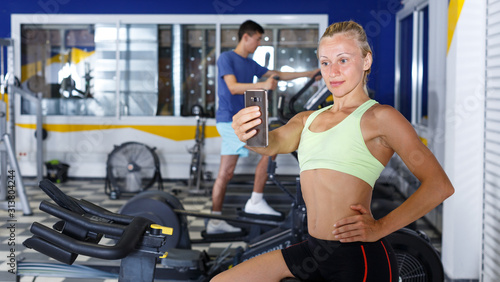 Woman taking selfie at gym