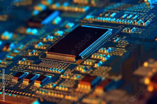 Electronic circuit board with electronic components such as chips close up. The concept of the electronic computer hardware technology.	 photo