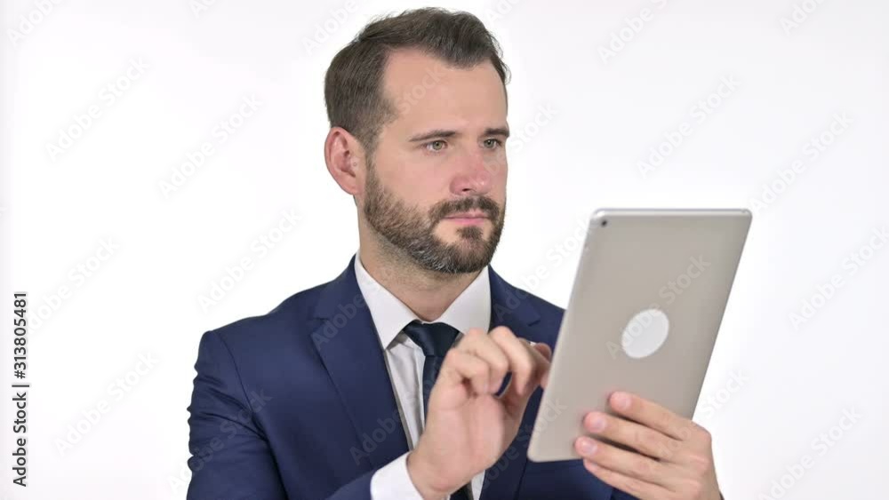 Serious Businessman using Tablet, White Background Serious Businessman using Tablet, White Background