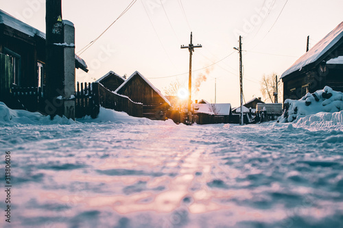  Siberian village in winter at sunset photo