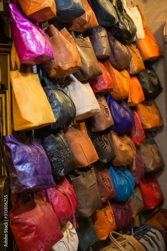 Leather handbags in the shop of a merchant in the souk of the medina of Fes in Morocco