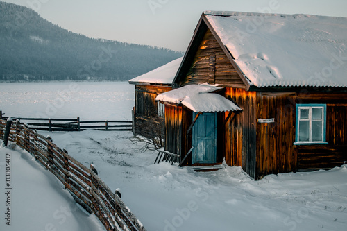  Siberian village in winter at sunset