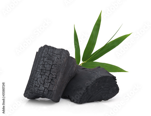 wood charcoal with bamboo leaf isolated on white background photo