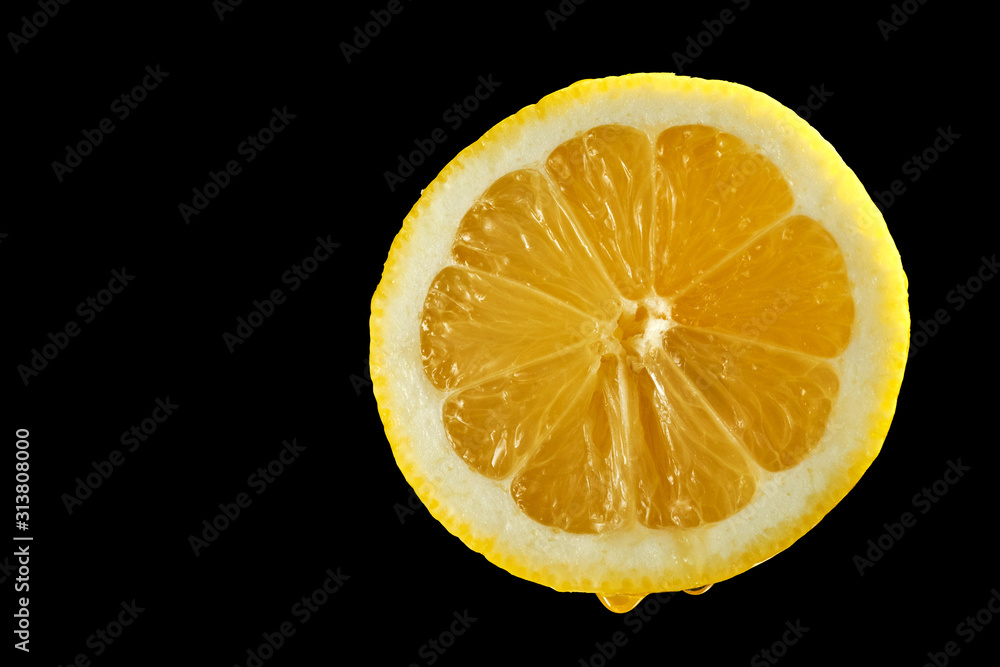 Closeup of half lemon with water droplets on black background Closeup of half lemon with water droplets on black background
