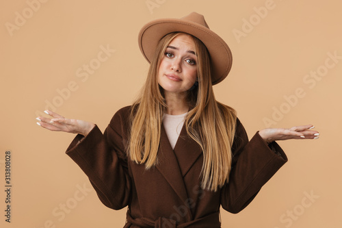 Image of young girl wearing hat shrugging and throwing up her hands